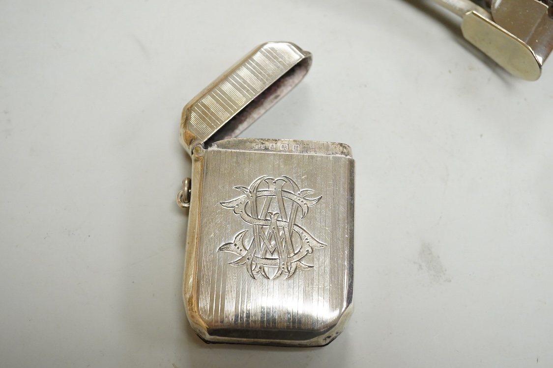 Small silver including two Edwardian caddy spoons, one German with import marks, a George V vesta case, a late Victorian pierced bonbon dish and a modern mounted steel cigar cutter.